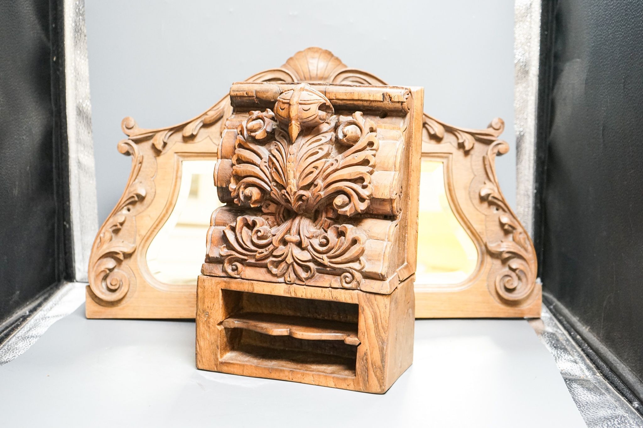 A carved Indian hardwood corbel shaped container, 33 cm, and carved beech mirror frame 59cm